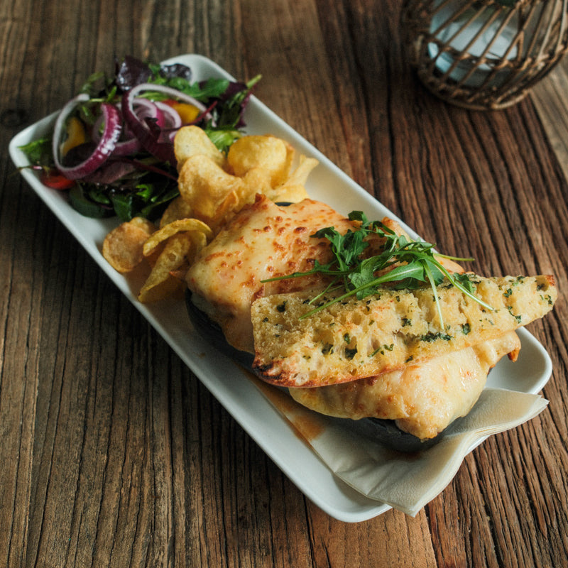 Baked fish with garlic bread, chips and salad